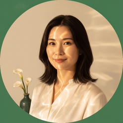 Circular portrait of Tomomi Sato, a woman with a serene expression, softly illuminated by warm, flowing light. Clean, warm cr