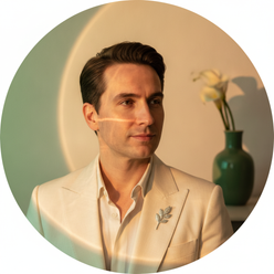 Circular portrait of Julian Miller with a thoughtful expression, against a warm cream background with subtle forest green lig