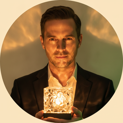 Circular portrait of Oliver Quinn, a man, with a discerning expression, holding the Crystal Water Ripple 16-Color LED Lamp, a